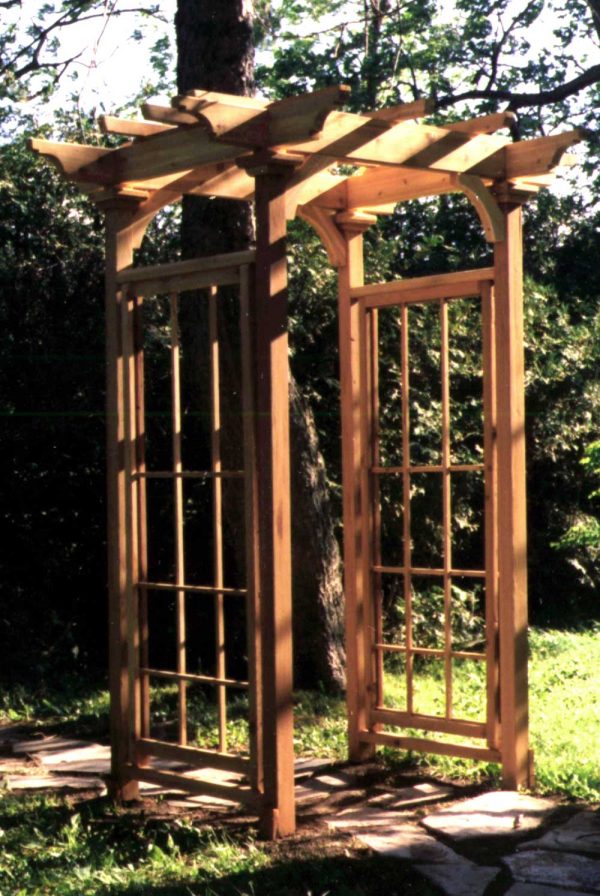 a wooden arbor with windows lattice
