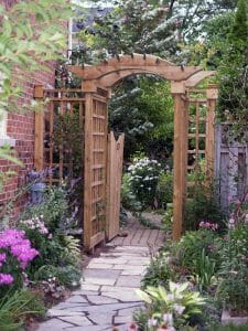 A gated garden entry arbor with trelliswork. Installed in North York Ontario