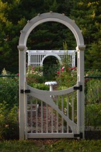 garden structure designs arbor and pergola plans. P121 pergola plan is in the distance. The custom gate in the foreground features a laminated headpiece and flowing gate design